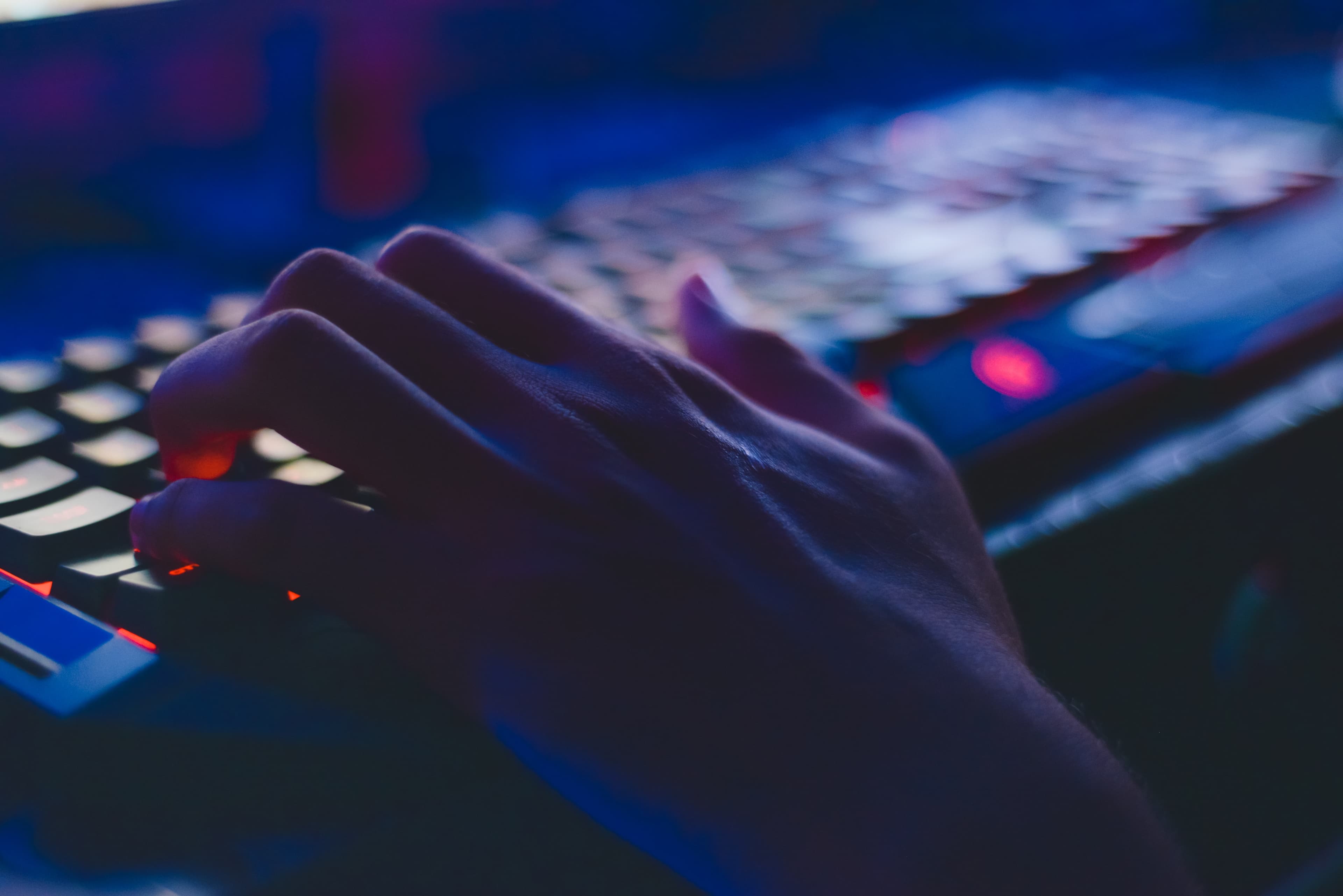 Person playing a game on a mechanical keyboard, photo by Soumil Kumar