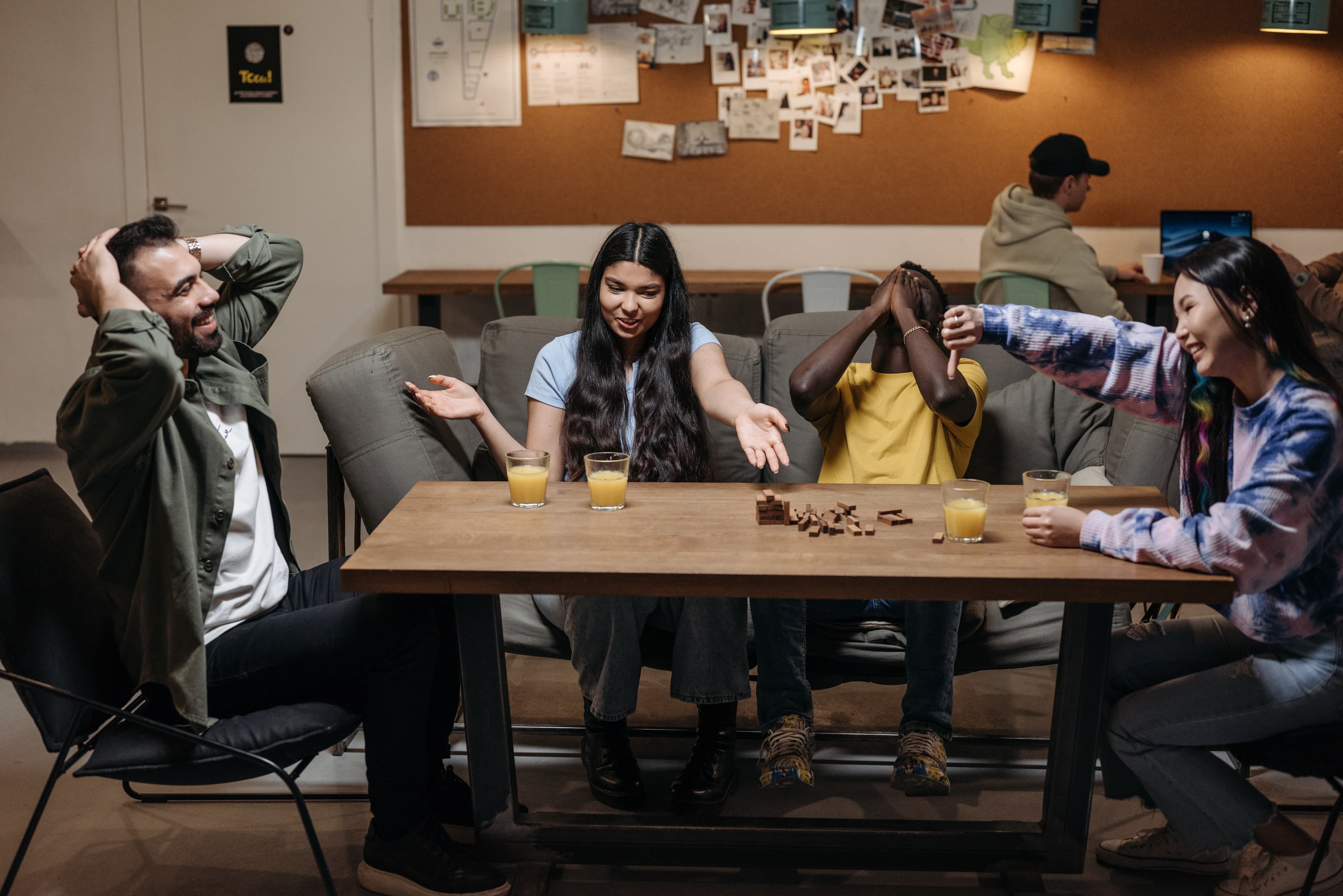 People playing a game around a table, photo by Pavel Danilyuk